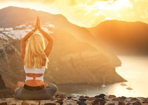 Woman meditating on a mountain, designing dream life